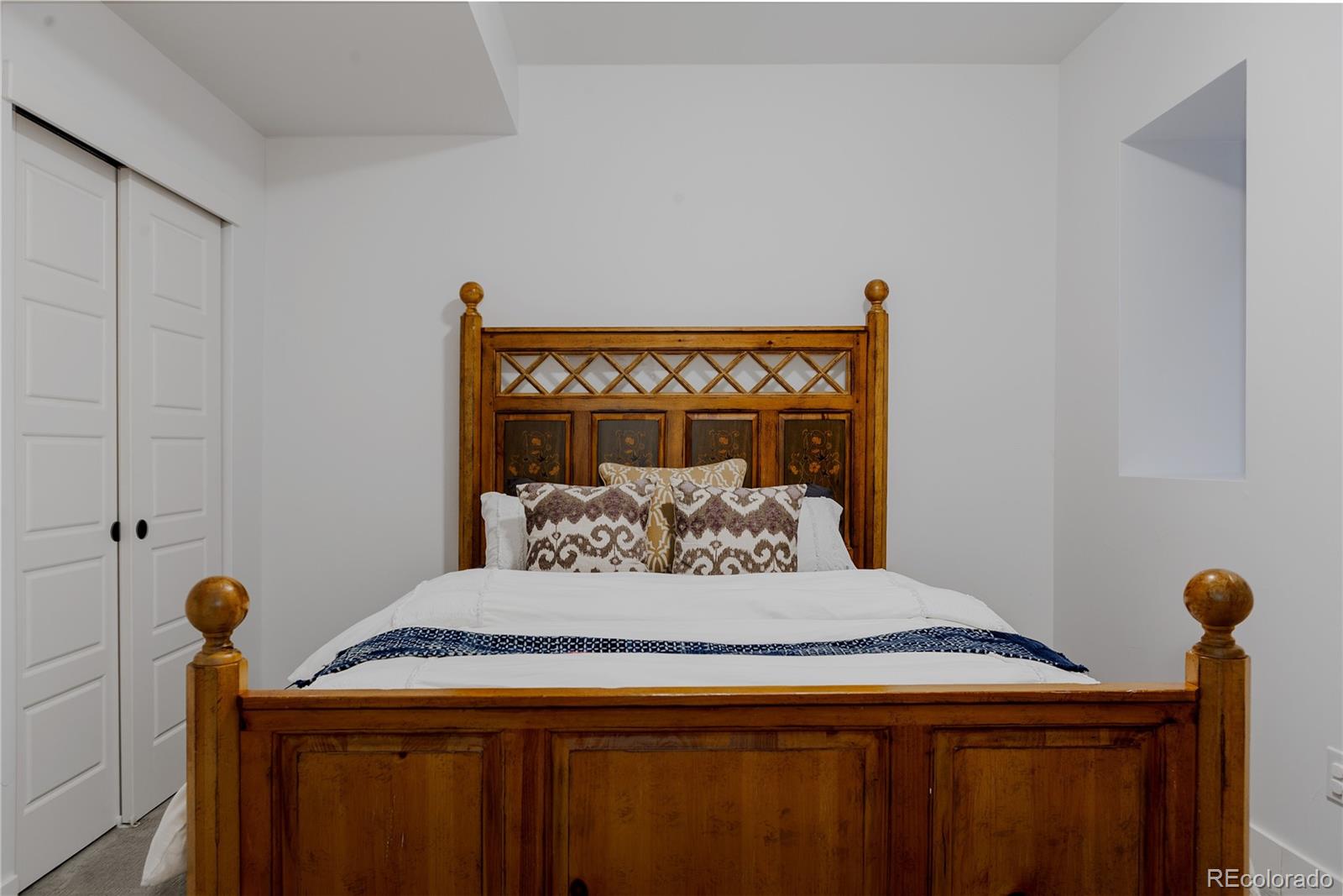 2645 Eudora Street Denver, CO 80207 - Photo 37 of 40 a bedroom with a bed and a table