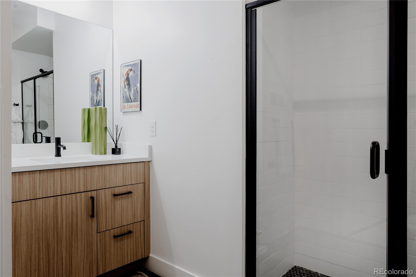 2645 Eudora Street Denver, CO 80207 - Photo 38 of 40 a bathroom with a sink and a mirror