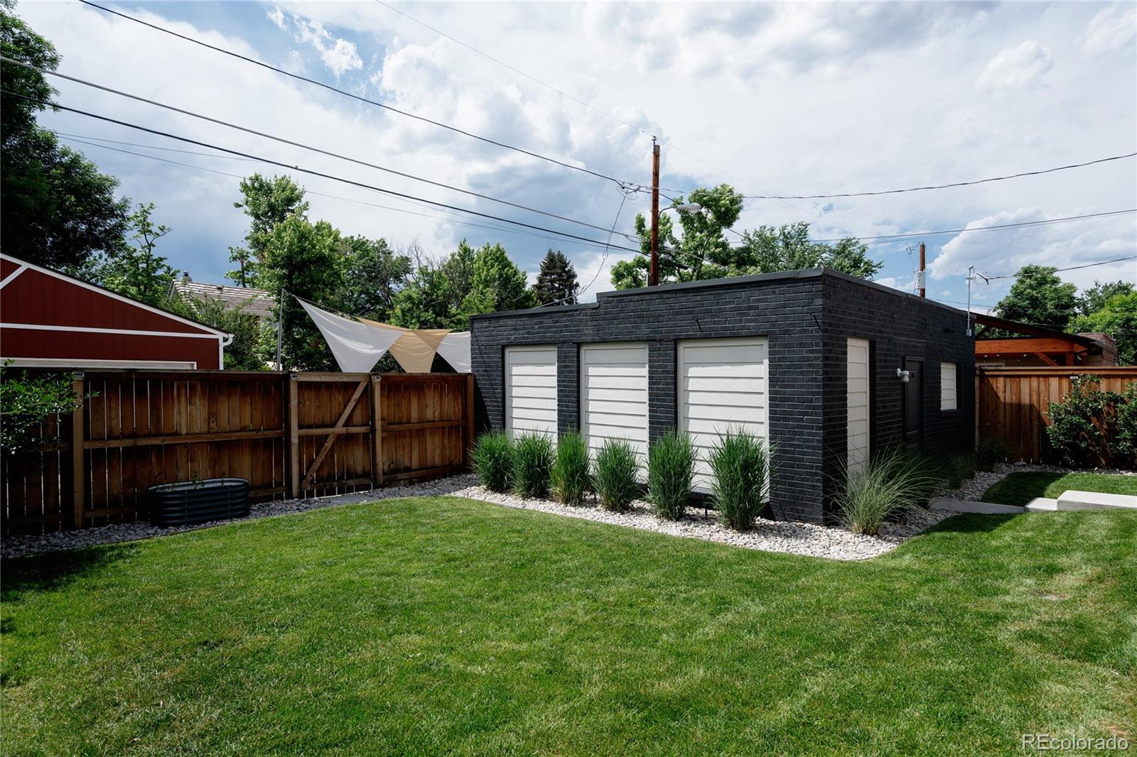 2645 Eudora Street Denver, CO 80207 - Photo 40 of 40 a view of a house with a small yard and a large tree