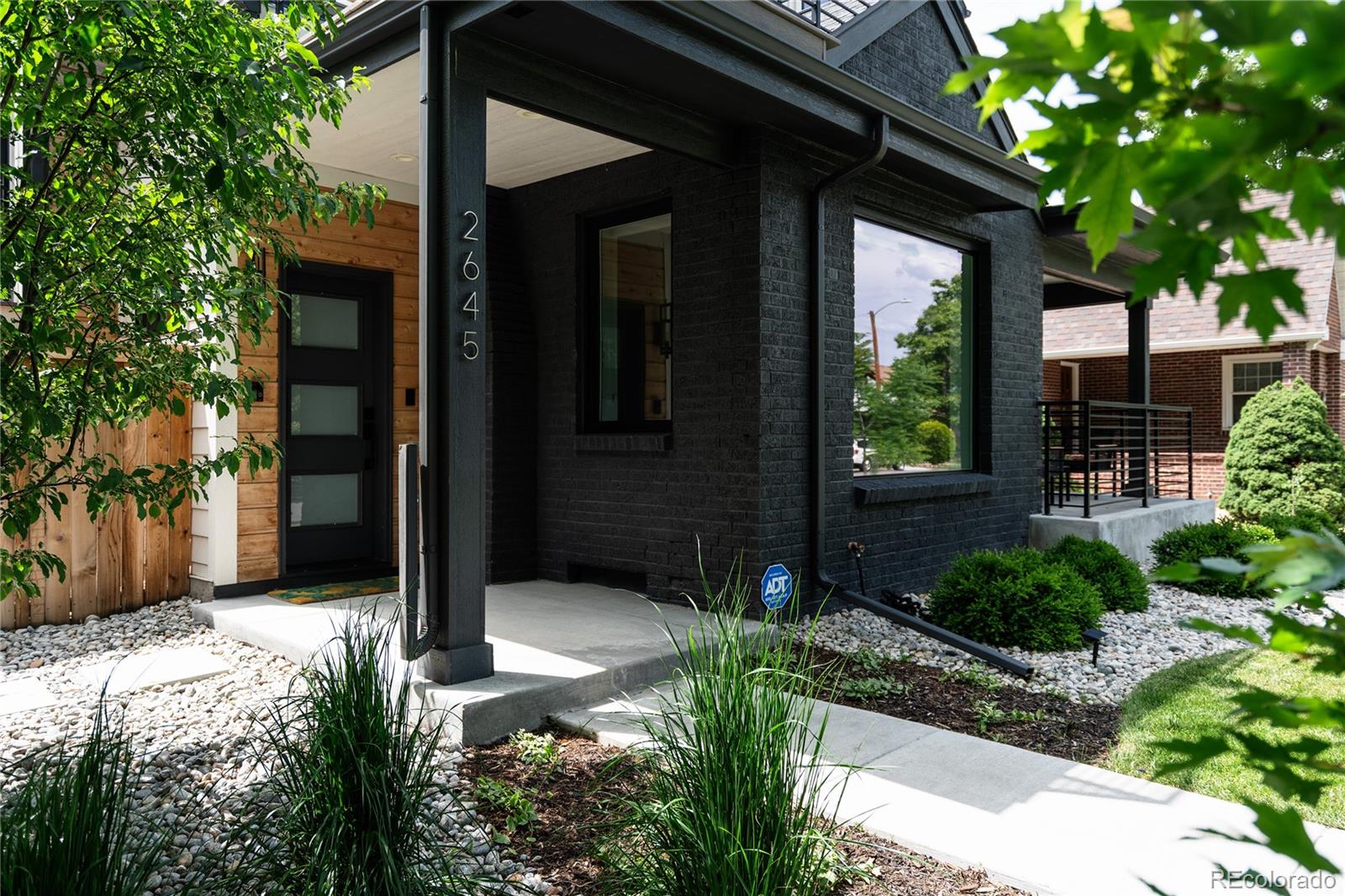 2645 Eudora Street Denver, CO 80207 - Photo 4 of 40 a couple of flower plants in front of door