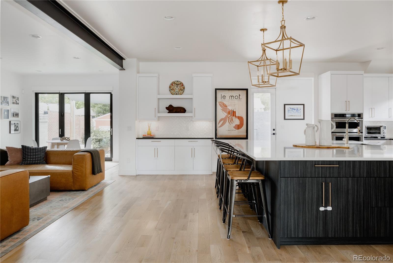 2645 Eudora Street Denver, CO 80207 - Photo 5 of 40 a living room with furniture and a wooden floor