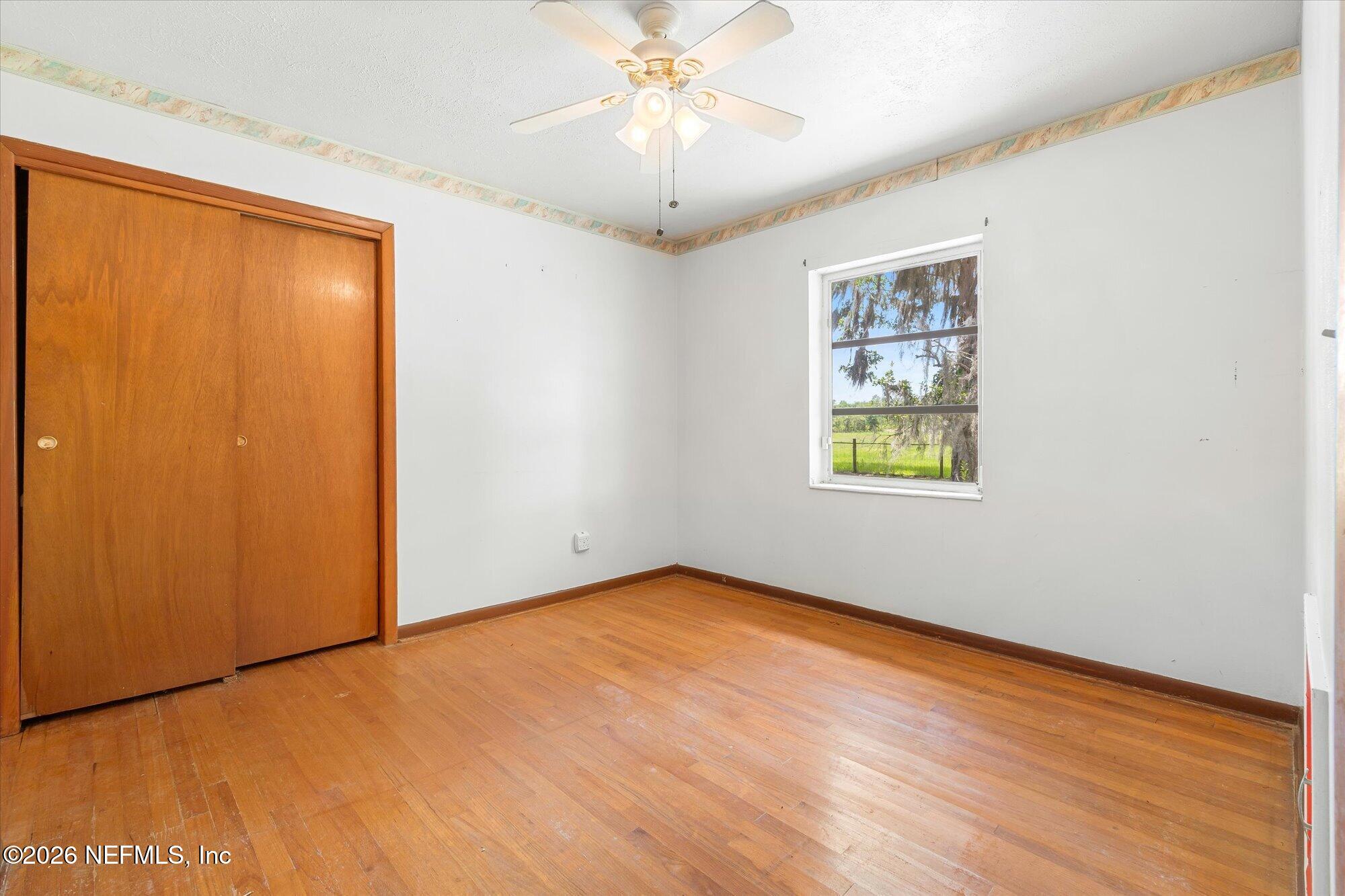 786 West River Road Palatka, FL 32177 - Photo 19 of 53 an empty room with windows and fan