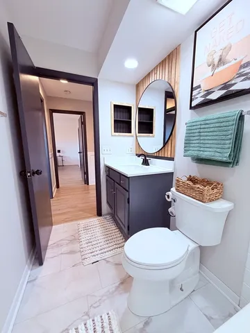 a living room with a bed furniture and a wooden floor
