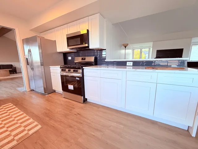 a living room with furniture kitchen and a kitchen