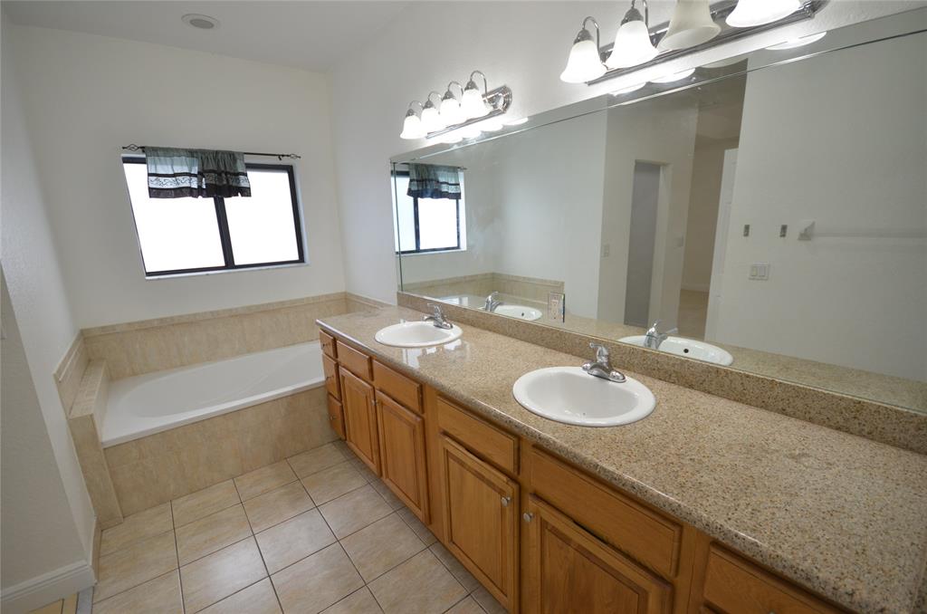 14483 Southwest 13th Terrace Miami, FL 33184 - Photo 13 of 27 a bathroom with a granite countertop sink tub and a mirror