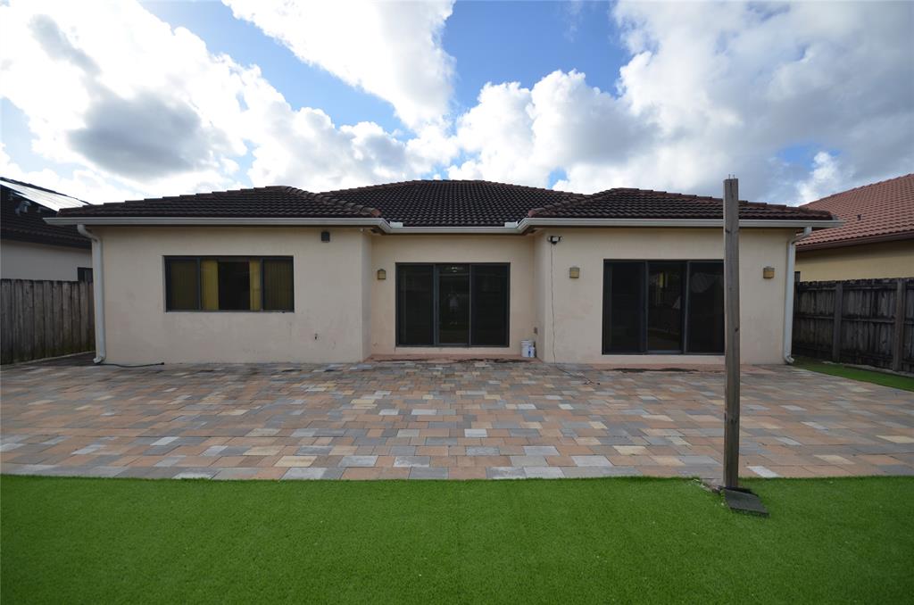 14483 Southwest 13th Terrace Miami, FL 33184 - Photo 23 of 27 a house that has a big yard with wooden fence