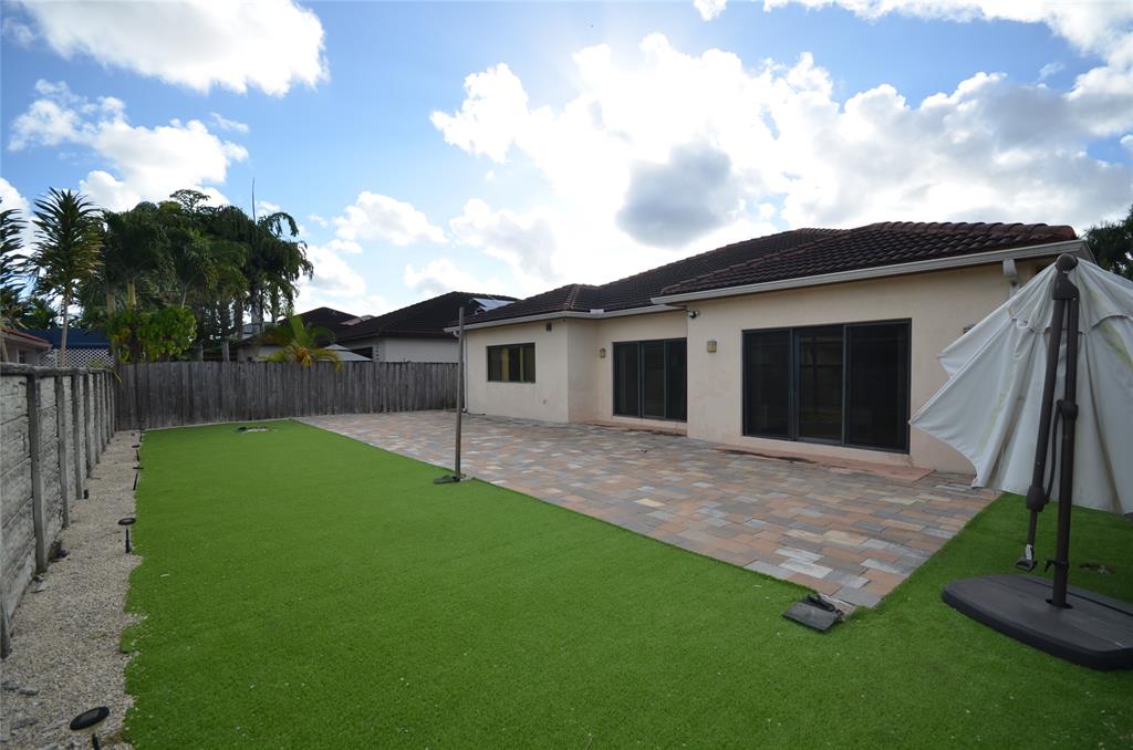 14483 Southwest 13th Terrace Miami, FL 33184 - Photo 24 of 27 a view of a backyard with plants and a backyard