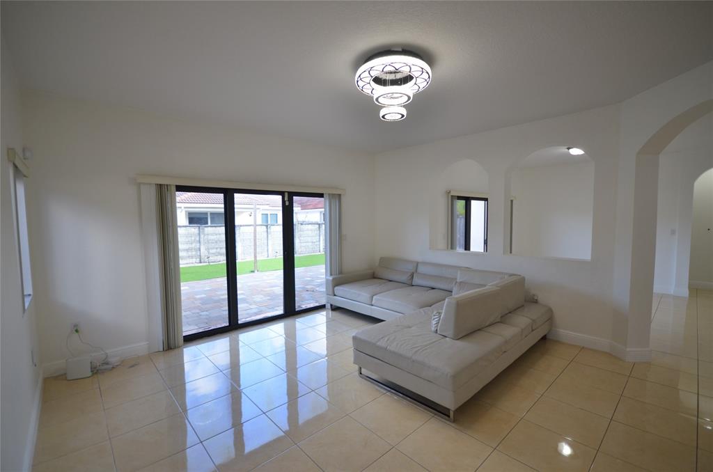 14483 Southwest 13th Terrace Miami, FL 33184 - Photo 9 of 27 a living room with furniture and a large window