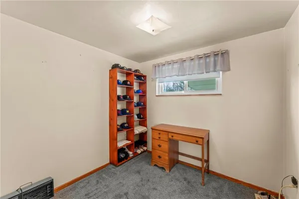 a room with a book shelf and a window