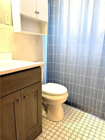 a bathroom with a toilet and a shower