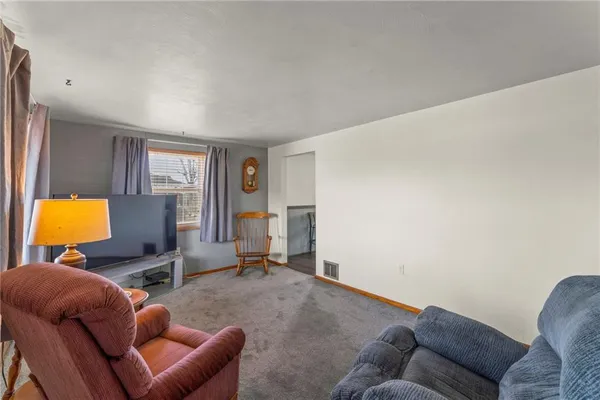 a living room with furniture and a lamp