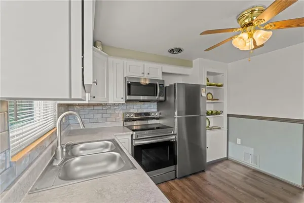 a kitchen with a refrigerator sink and stove