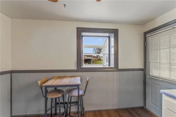 a view of a dining room with furniture and window