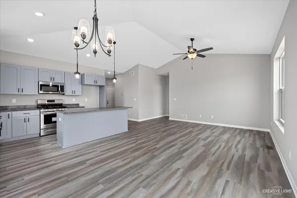 a view of kitchen and sink cabinet with wooden floor