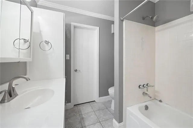 a bathroom with a tub sink vanity and toilet
