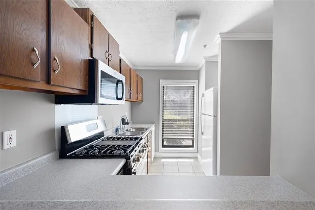 a room with wooden cabinets and stove