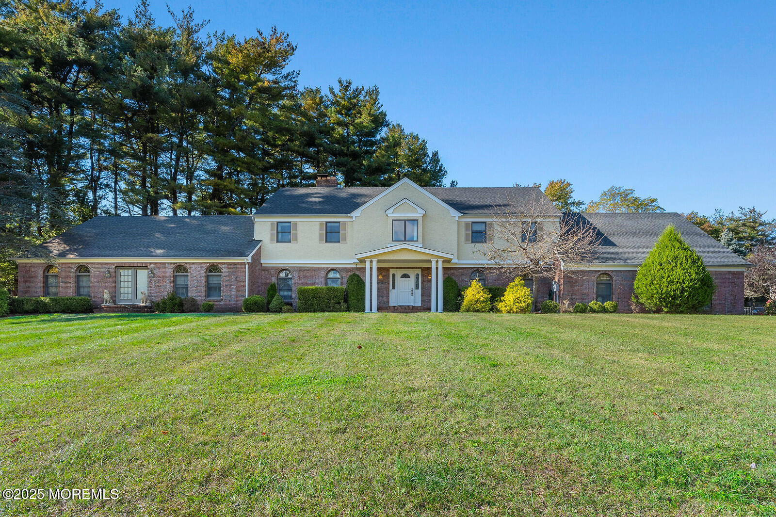 a front view of house with yard and green space