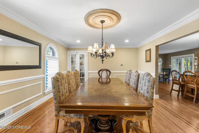 a view of a dining room with furniture and a chandelier