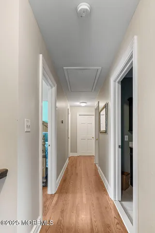 a view of empty room with wooden floor and window