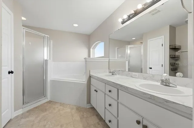 a bathroom with a double vanity sink and a mirror