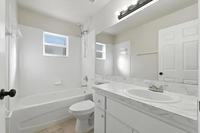 a bathroom with a sink a toilet and a bathtub