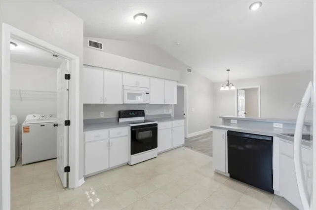 a large kitchen with a stove and a sink