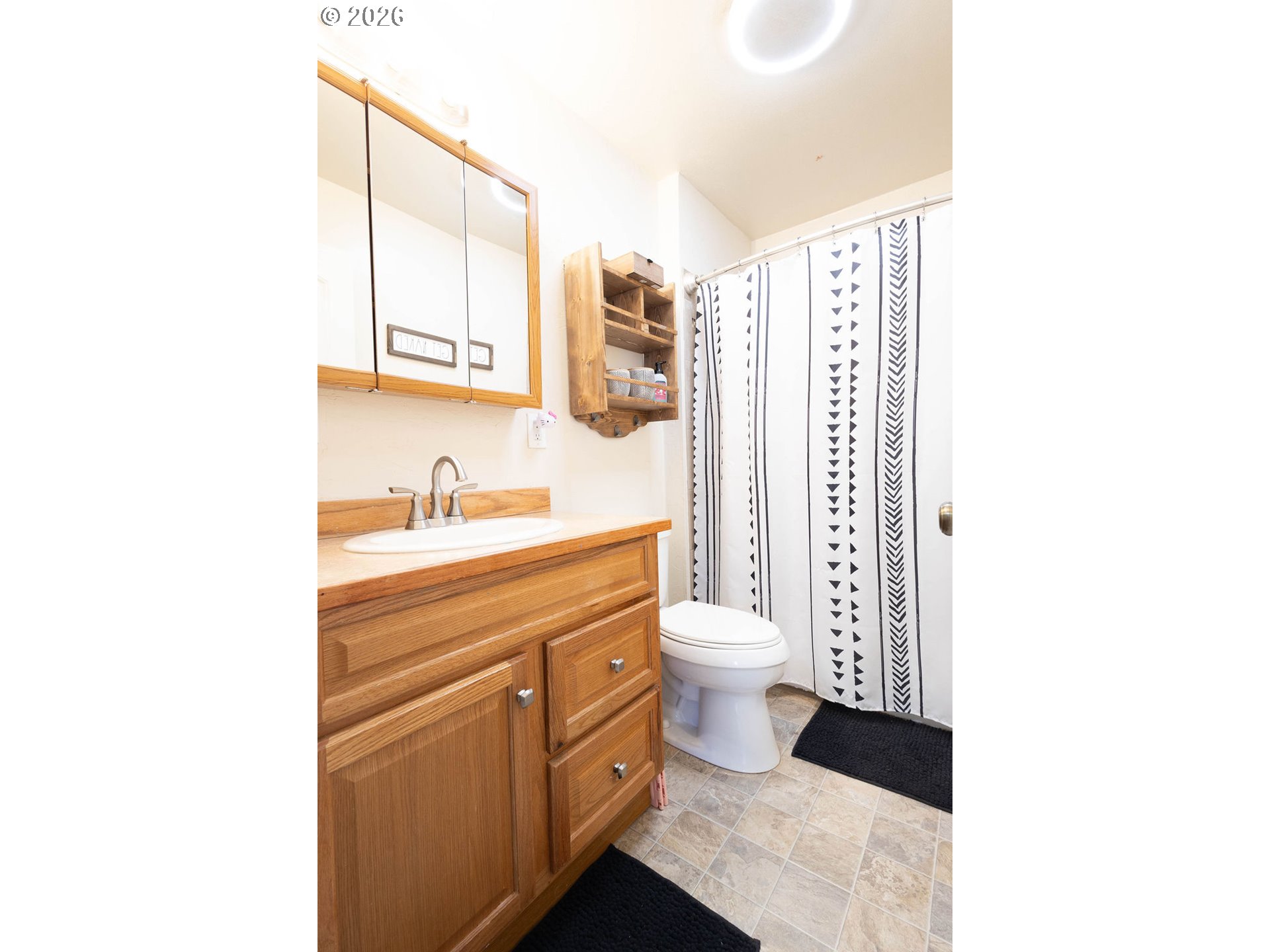 2703 North Spruce Street La Grande, OR 97850 - Photo 19 of 37 a bathroom with a toilet sink and a mirror