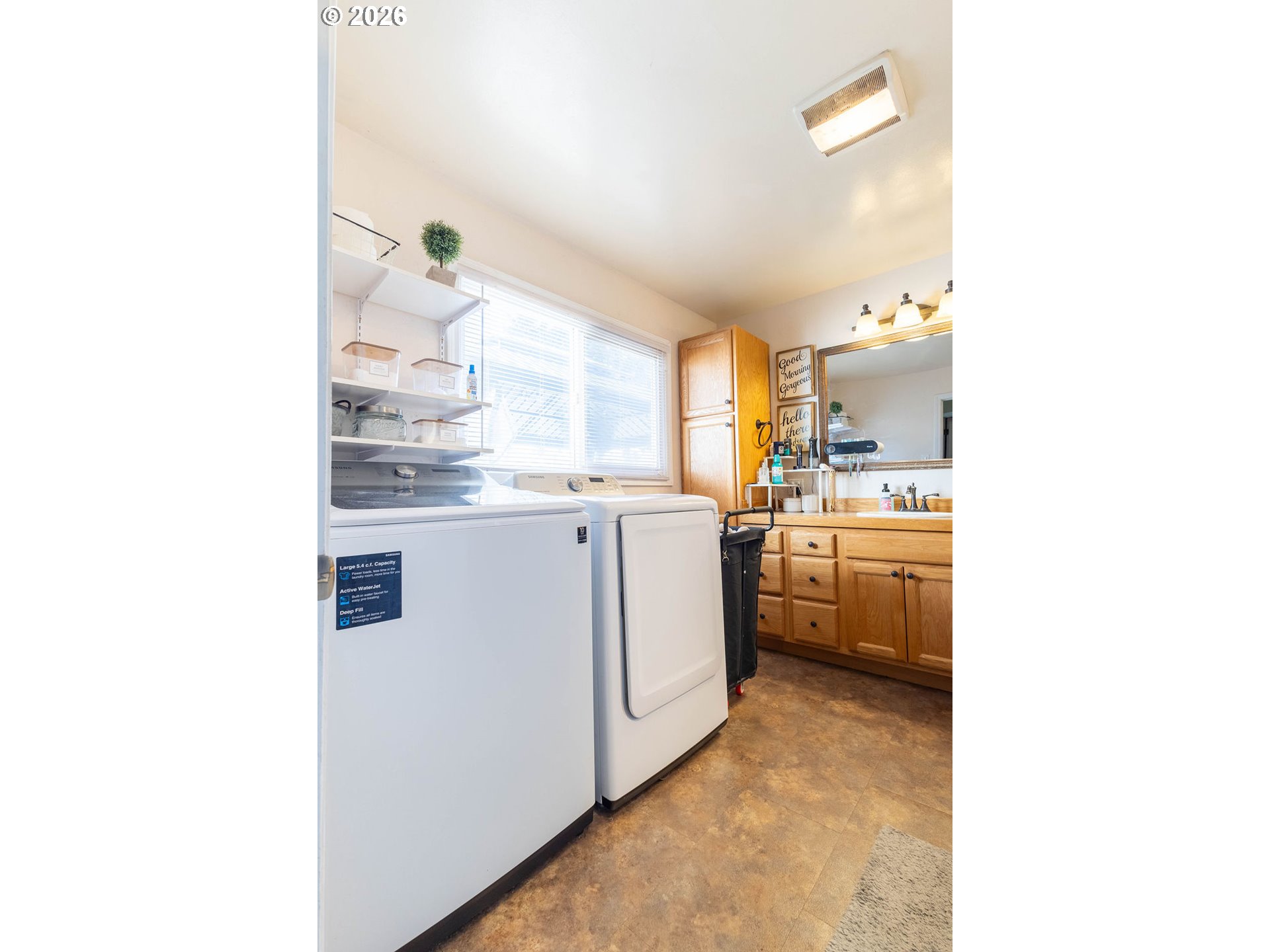 2703 North Spruce Street La Grande, OR 97850 - Photo 23 of 37 a kitchen with cabinets and white appliances