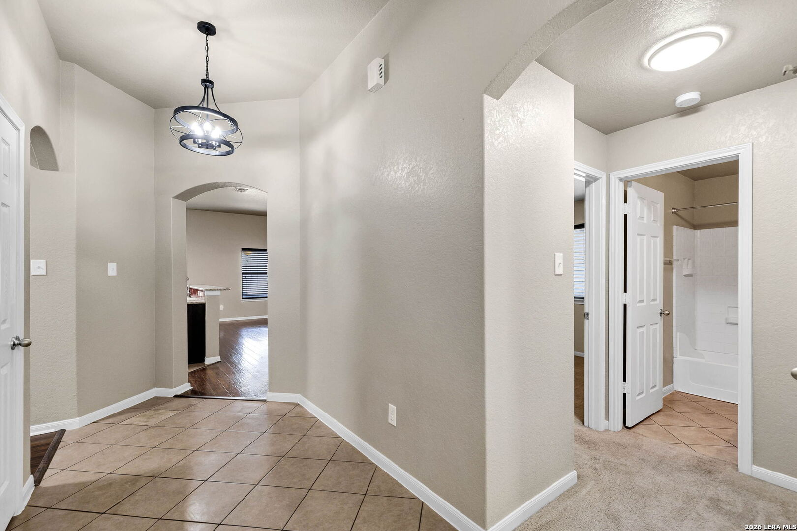 4015 Shervin Way Converse, TX 78109 - Photo 8 of 43 a view of a hallway with wooden floor and a bathroom