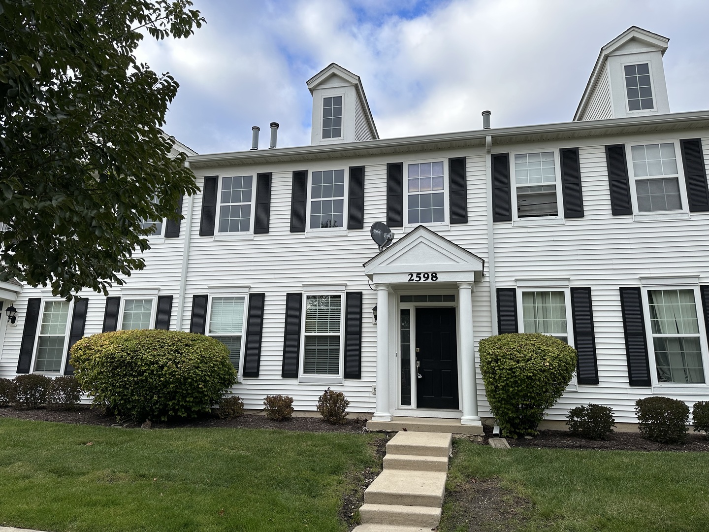 a front view of a house with a yard