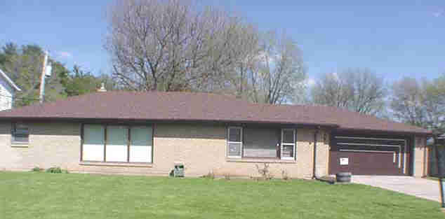 1003 North Alpine Road Rockford, IL 61107 - Photo 1 of 4 a front view of a house with a garden and yard
