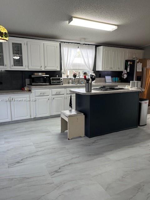Martin County Stuart, FL 34997 - Photo 2 of 20 a kitchen with kitchen island granite countertop a stove and a sink