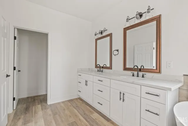 a bathroom with a double vanity sink and mirror