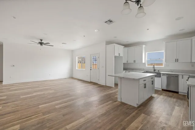 a kitchen with white cabinets and white appliances