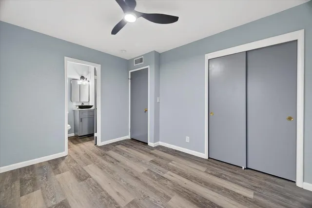 a view of empty room with wooden floor