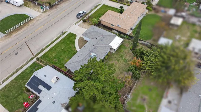 an aerial view of a house with a yard