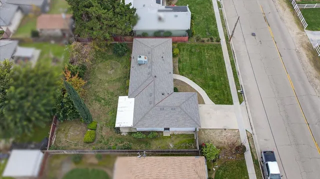 an aerial view of a house with a garden and lake view