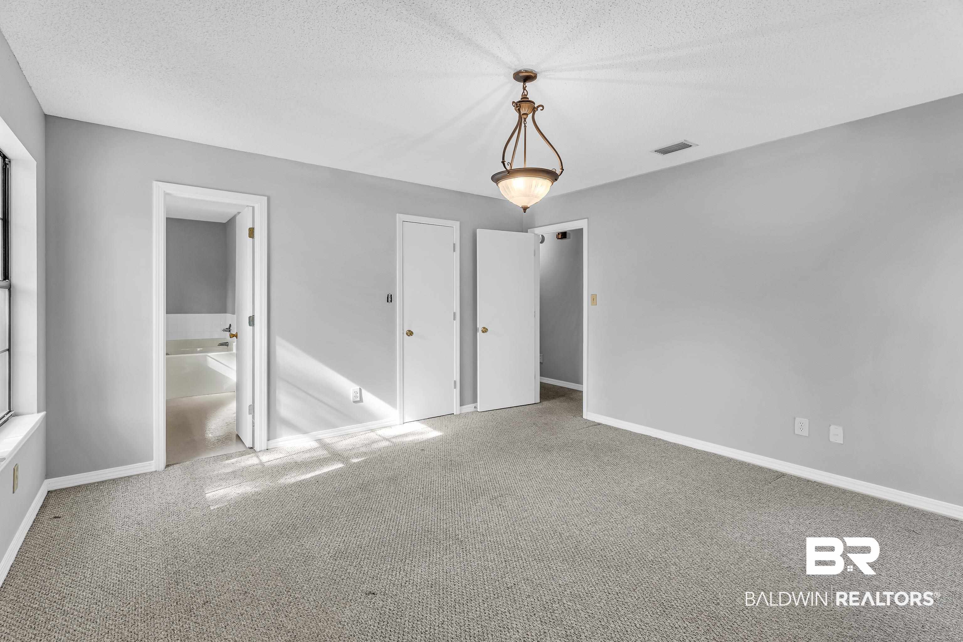 7787 Bellingrath Road Theodore, AL 36582 - Photo 24 of 36 Unfurnished bedroom featuring carpet and a textured ceiling