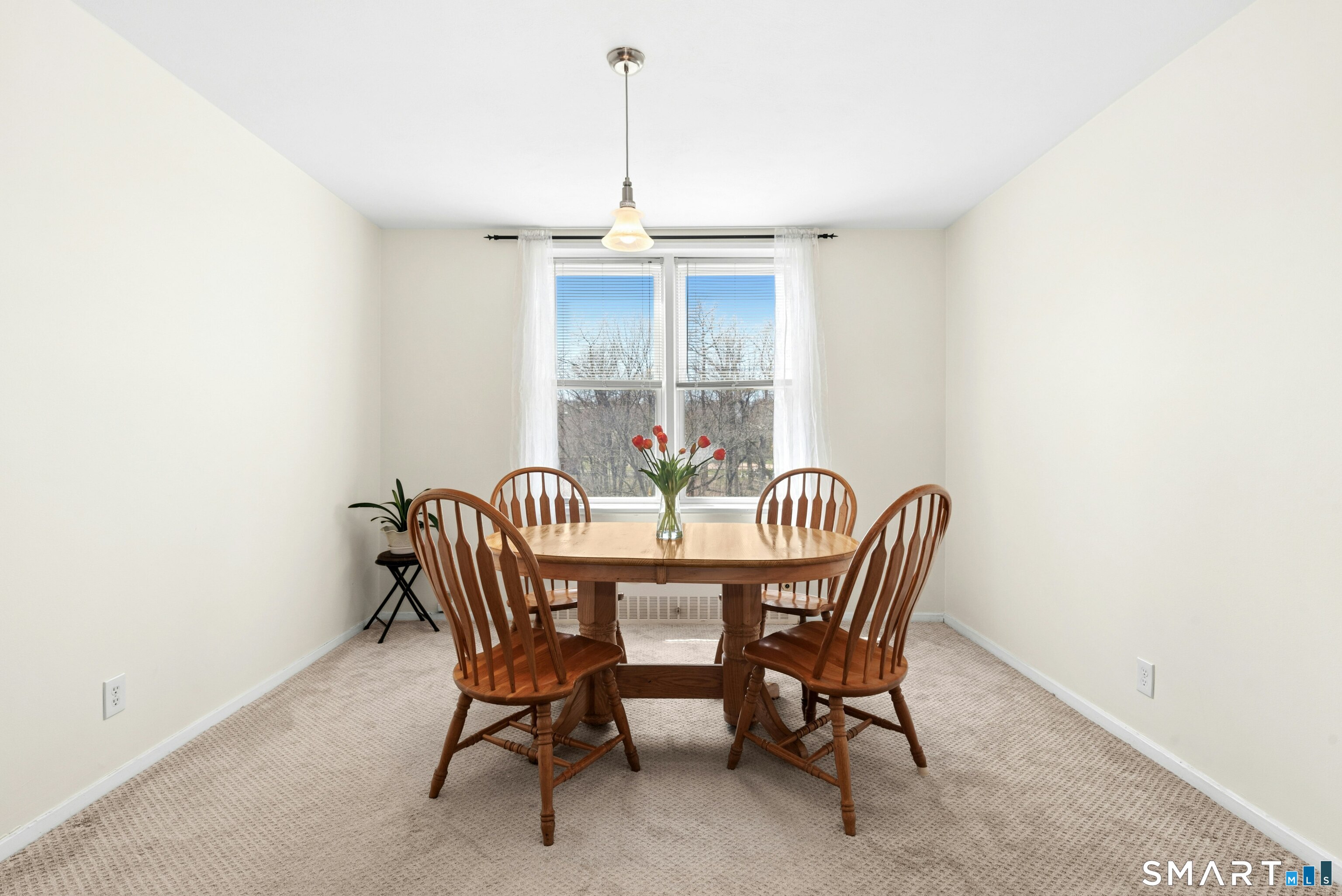 7 4th Street, Unit 3C Stamford, CT 06905 - Photo 11 of 21 a view of a dining room with furniture window and outside view
