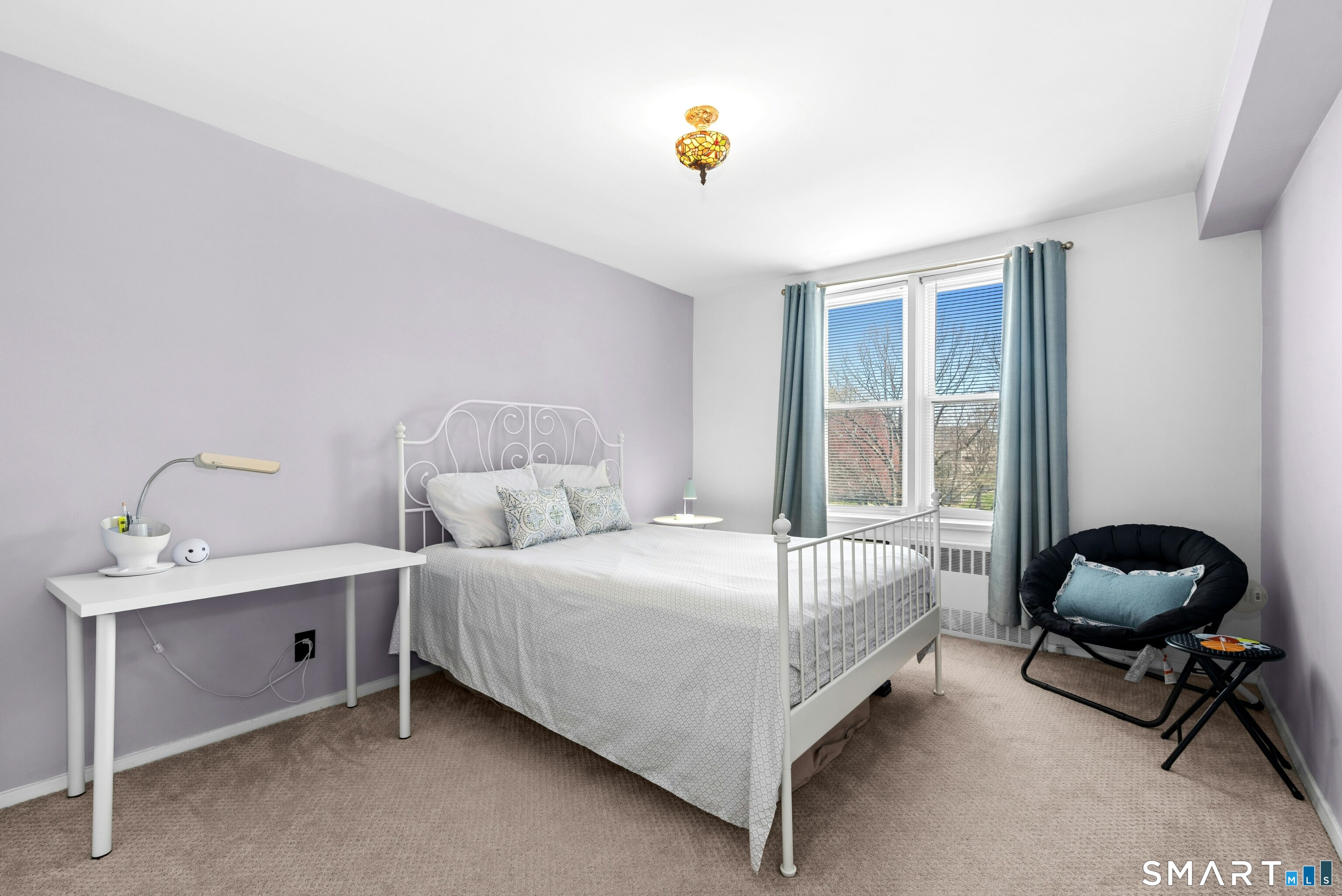 7 4th Street, Unit 3C Stamford, CT 06905 - Photo 18 of 21 a bedroom with a bed chair and a window