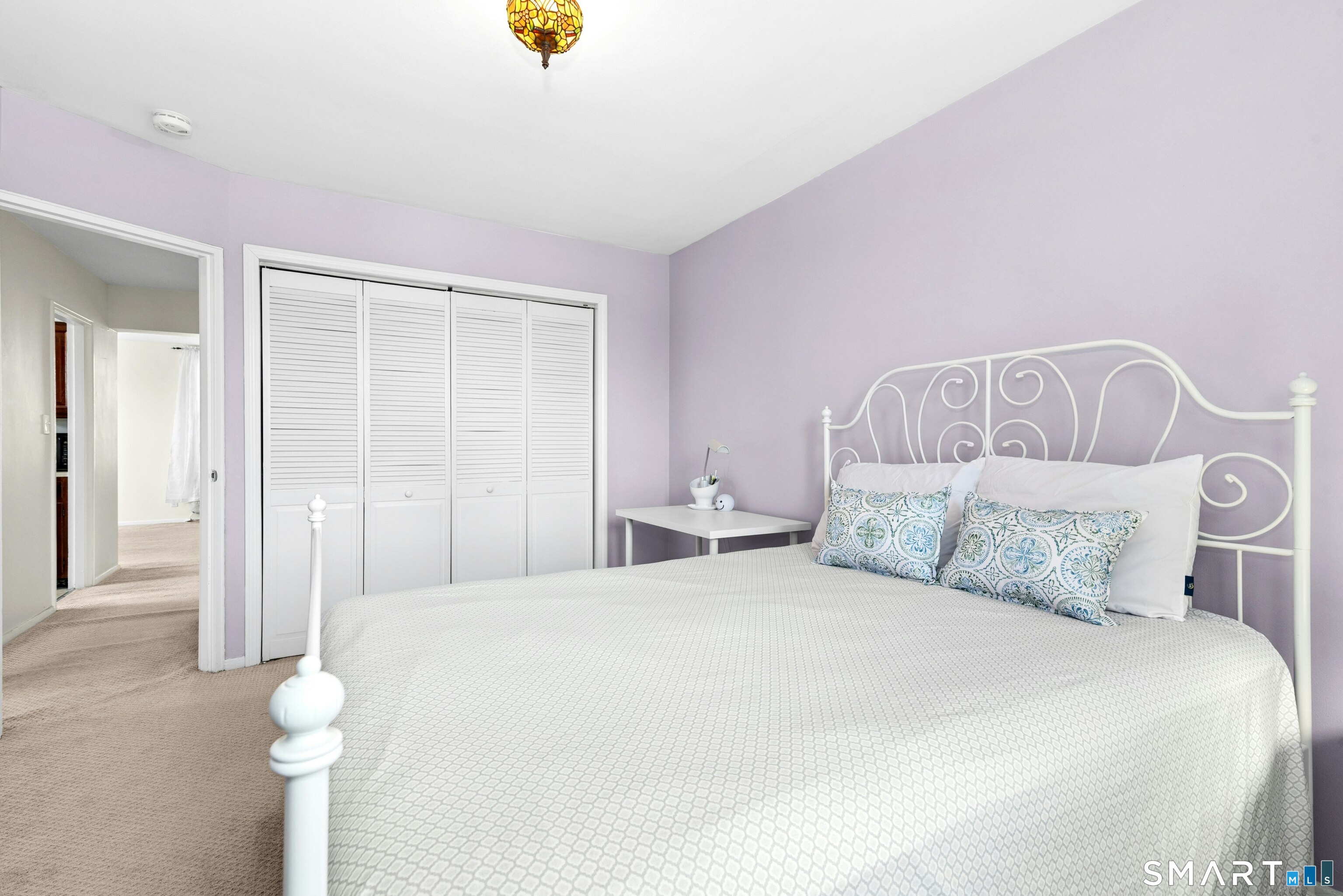 7 4th Street, Unit 3C Stamford, CT 06905 - Photo 19 of 21 a bedroom with a bed and a chandelier