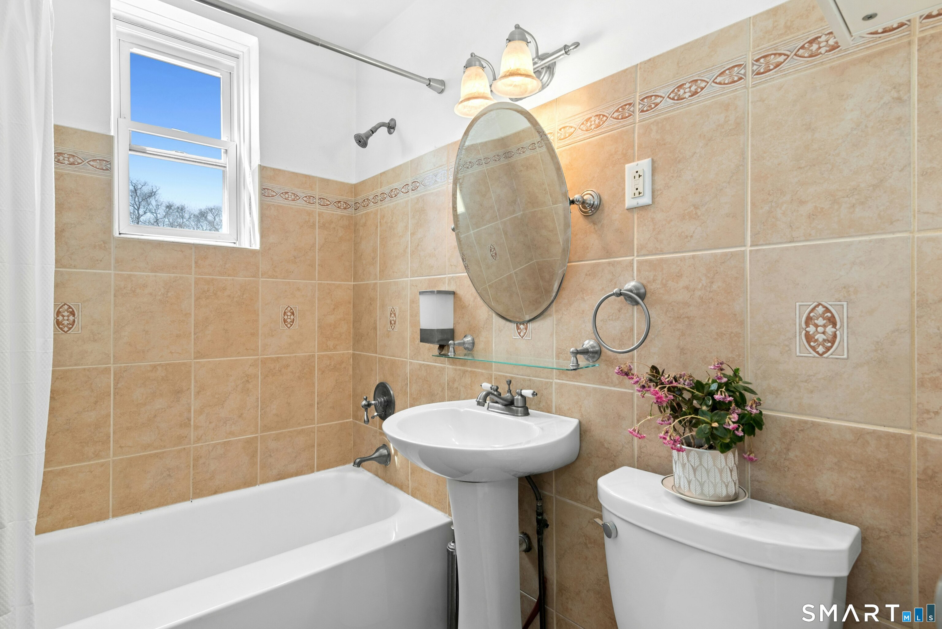 7 4th Street, Unit 3C Stamford, CT 06905 - Photo 20 of 21 a bathroom with a sink a mirror a toilet and a bathtub