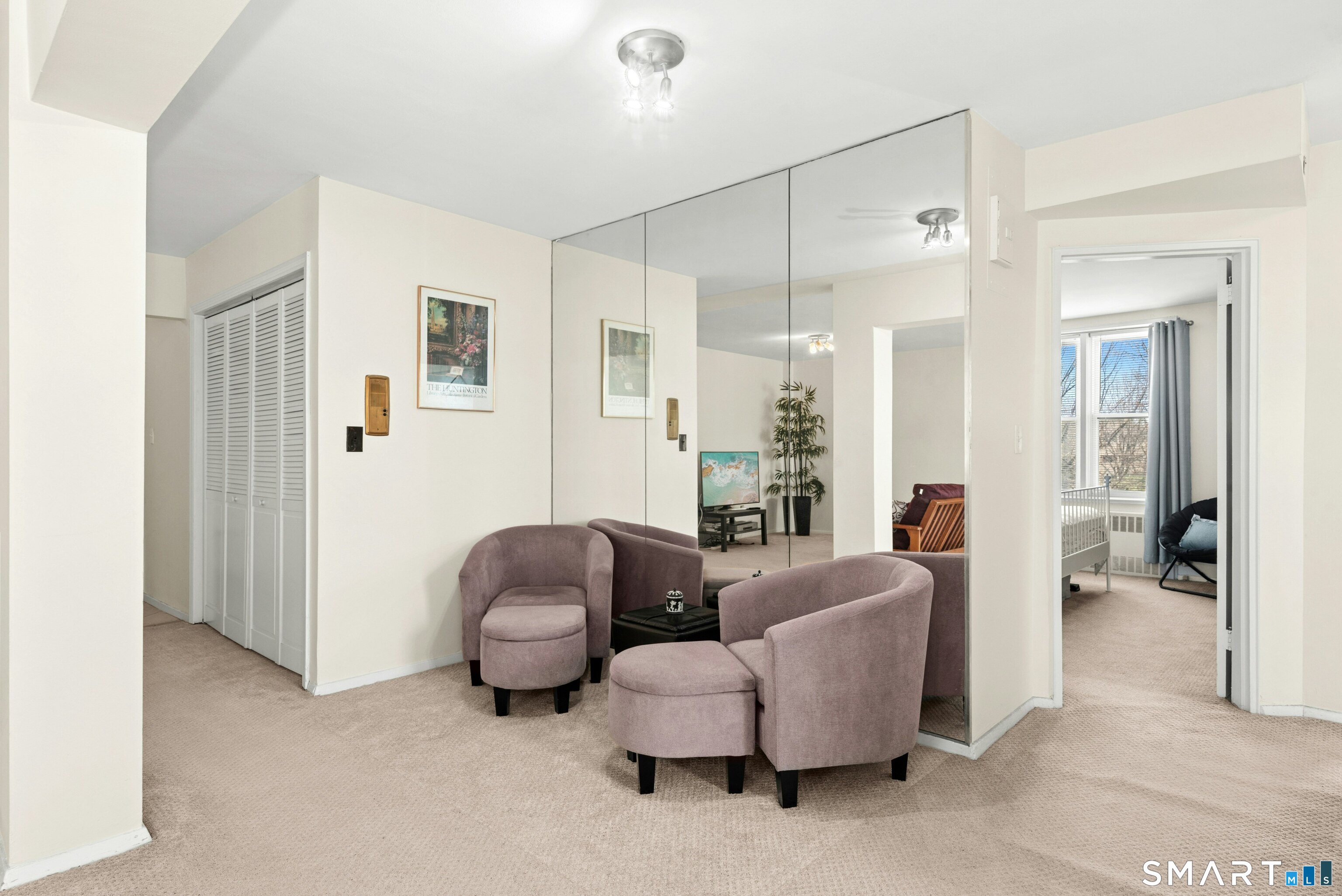 7 4th Street, Unit 3C Stamford, CT 06905 - Photo 6 of 21 a living room with furniture and a chandelier