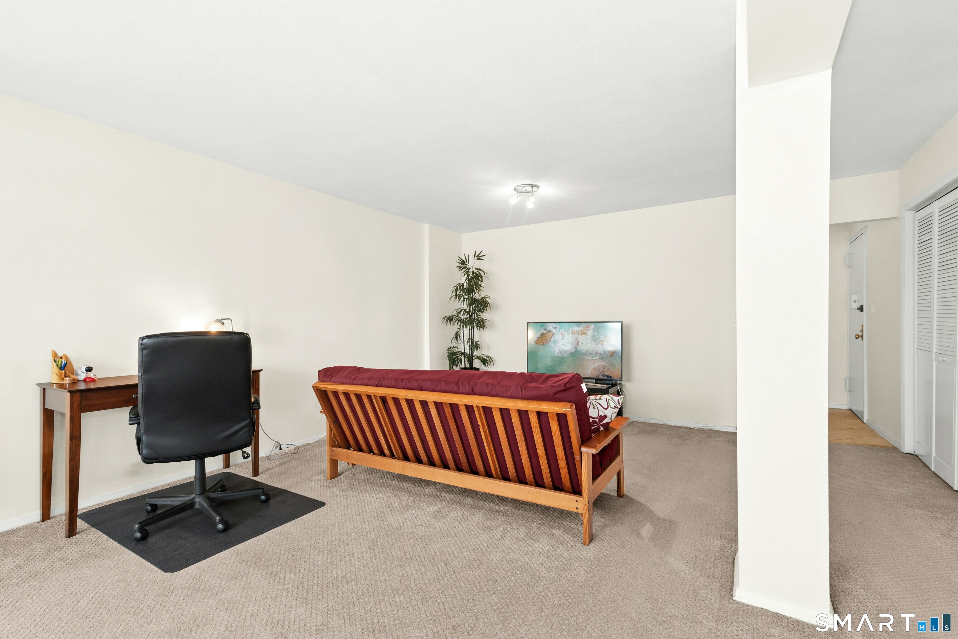 7 4th Street, Unit 3C Stamford, CT 06905 - Photo 9 of 21 a bedroom with a bed and chair