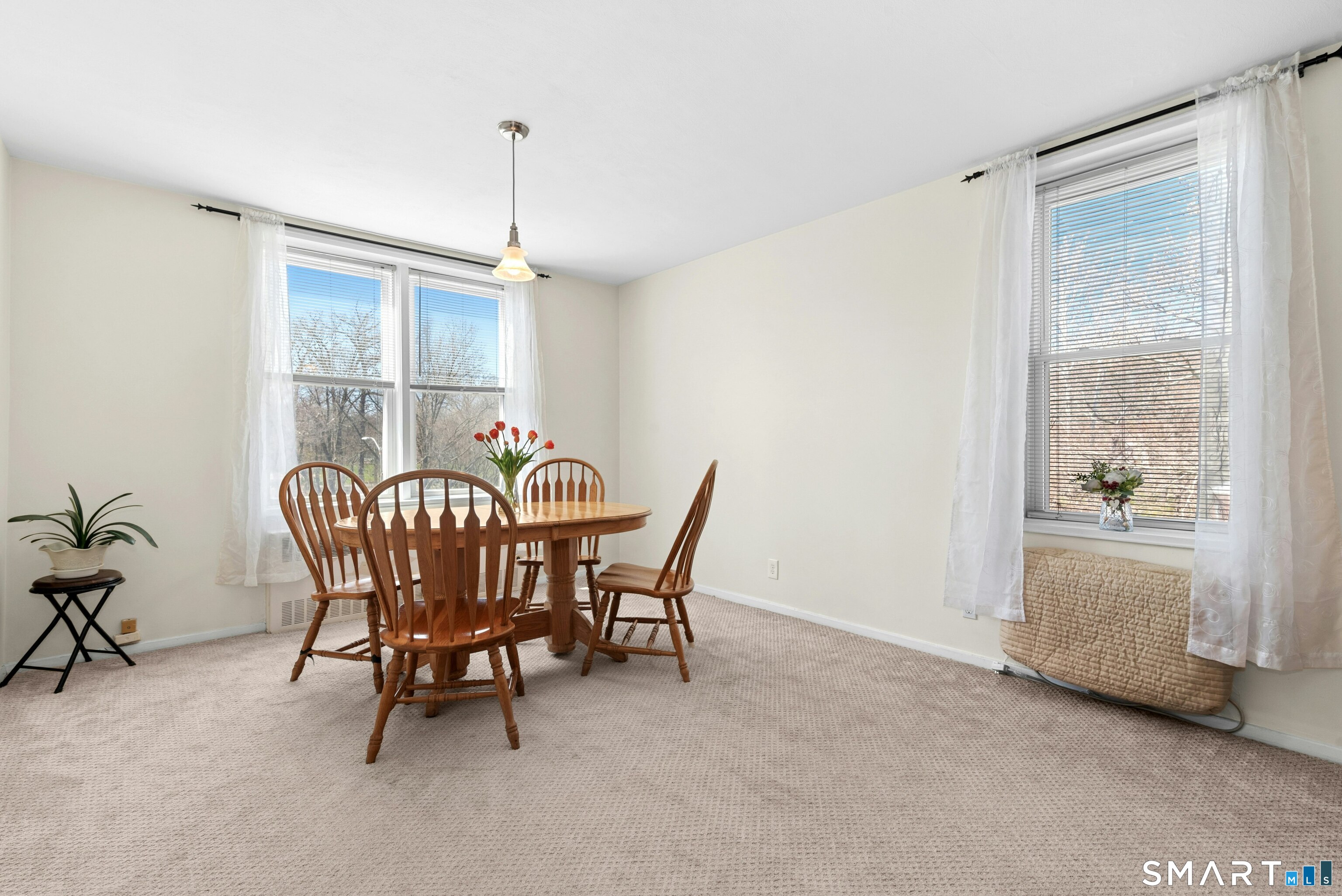 7 4th Street, Unit 3C Stamford, CT 06905 - Photo 10 of 21 a view of a dining room with furniture window and outside view