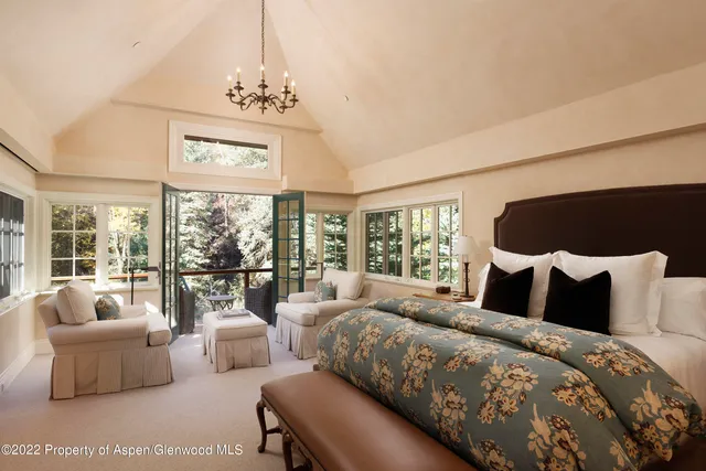 a bedroom with a large bed and a large window