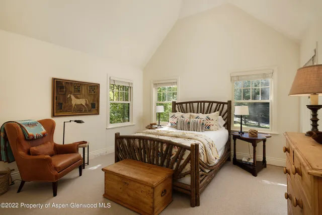 a bedroom with a bed couch and window