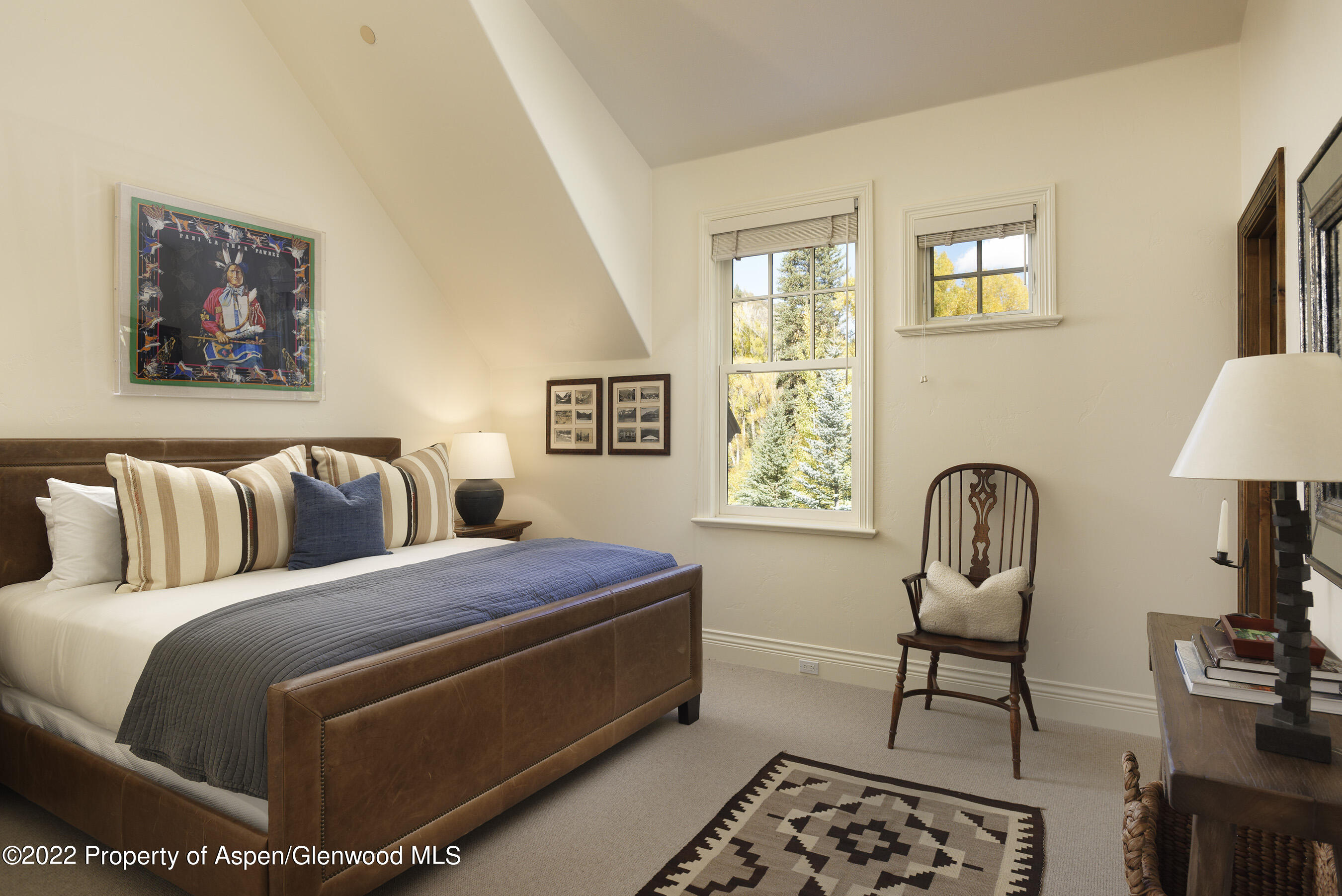 333 Snowmass Creek Road Snowmass, CO 81654 - Photo 20 of 41 a bedroom with a bed and a potted plant on the dresser