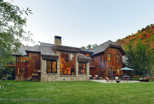 front view of a brick house with a yard