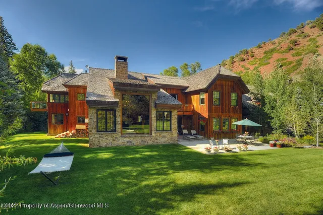 a front view of a house with a yard table and chairs